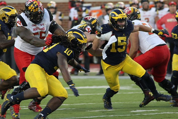 Devin Bush (10) and Chase Winovich (15)