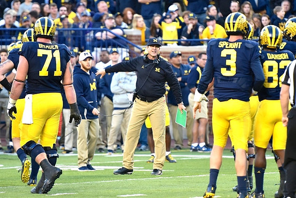 Ben Braden (71), Jim Harbaugh, Wilton Speight (3), and Amara Darboh (82)