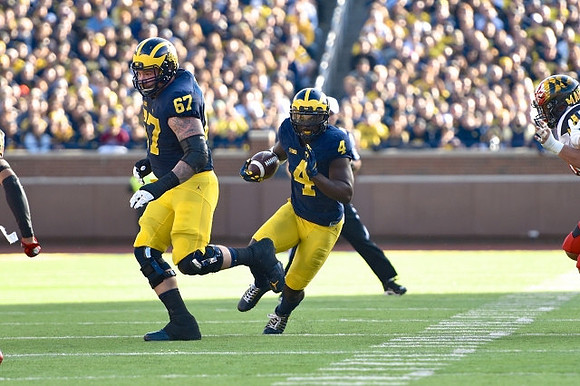 Kyle Kalis (67) and De'Veon Smith (4)