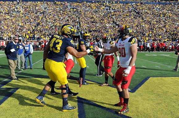 Rick Leach, Chris Wormley (43), and Jake Butt (88)