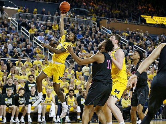 Zavier Simpson (3) and Jon Teske (15)