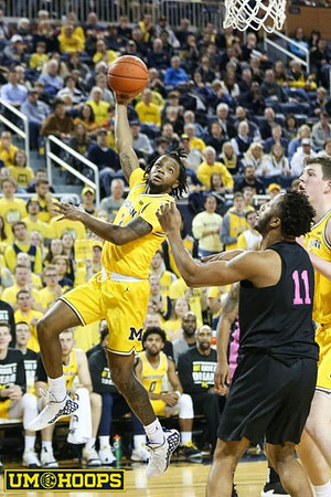 Zavier Simpson (3) and Jon Teske (15)