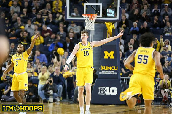 Zavier Simpson (3), Jon Teske (15), and Eli Brooks (55)