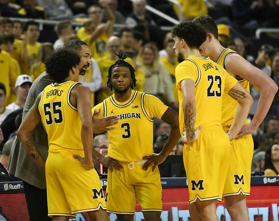 Eli Brooks (55), Juwan Howard, Zavier Simpson (3), Brandon Johns Jr. (23), and Jon Teske (15)