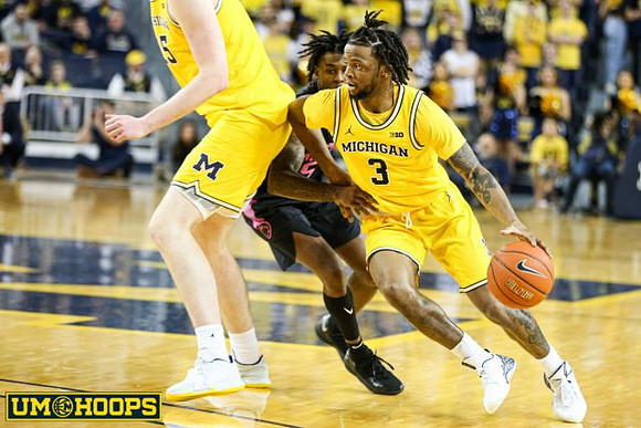 Jon Teske (15) and Zavier Simpson (3)