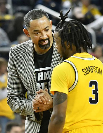 Zavier Simpson (3) and Juwan Howard