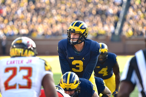 Mason Cole (52), Wilton Speight (3), and De'Veon Smith (4)