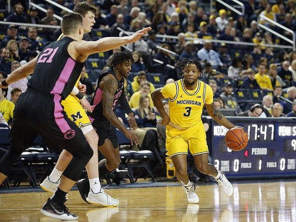 Jon Teske (15) and Zavier Simpson (3)