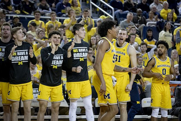 Eli Brooks (55) and Michigan Team