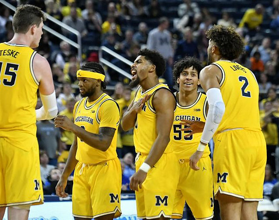 Jon Teske (15), Zavier Simpson (3), David DeJulius (0), Eli Brooks (55), and Isaiah Livers (2)