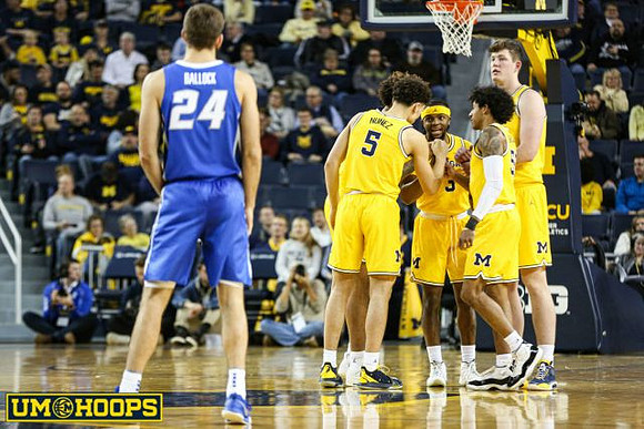 Isaiah Livers (2), Adrien Nunez (5), Zavier Simpson (3), Jon Teske (15), and Eli Brooks (55)