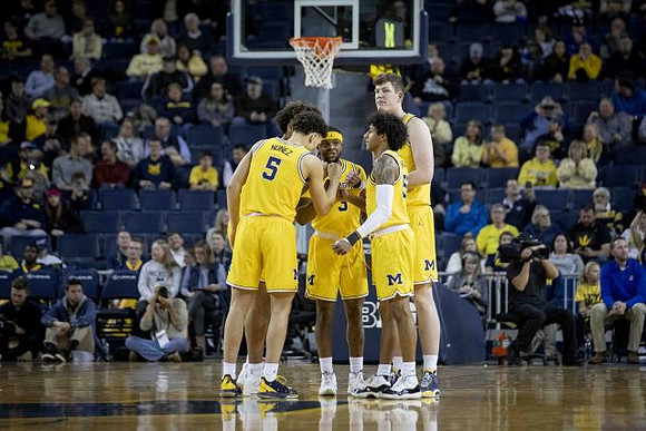 Isaiah Livers (2), Adrien Nunez (5), Zavier Simpson (3), Jon Teske (15), and Eli Brooks (55)