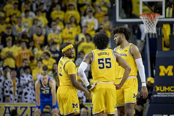 Zavier Simpson (3), Eli Brooks (55), and Isaiah Livers (2)