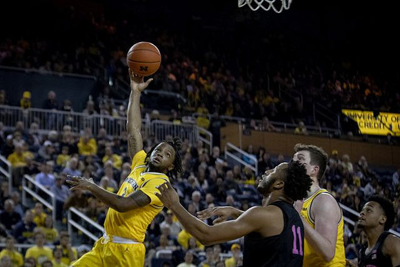 Zavier Simpson (3) and Jon Teske (15)