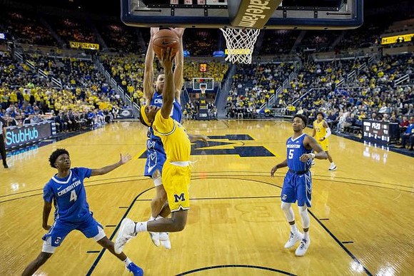 Zavier Simpson (3) and Eli Brooks (55)