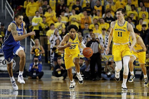 Eli Brooks (55), Colin Castleton (11), and Brandon Johns Jr. (23)
