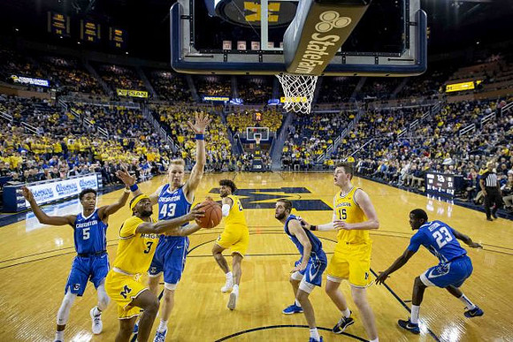 Zavier Simpson (3), Isaiah Livers (2), and Jon Teske (15)