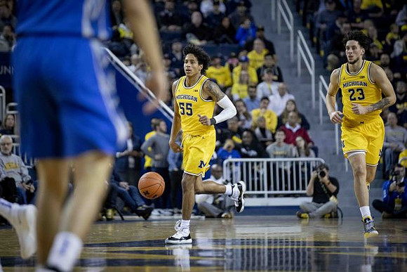 Eli Brooks (55) and Brandon Johns Jr. (23)