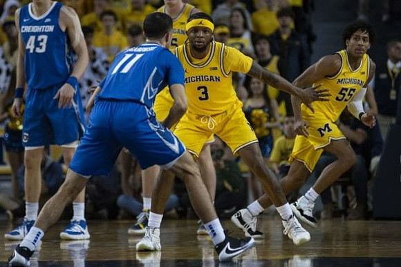 Jon Teske (15), Zavier Simpson (3), and Eli Brooks (55)