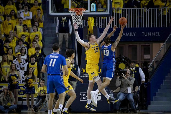 Adrien Nunez (5) and Jon Teske (15)