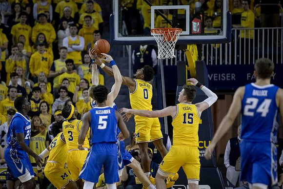 Eli Brooks (55), Zavier Simpson (3), David DeJulius (0), and Jon Teske (15)