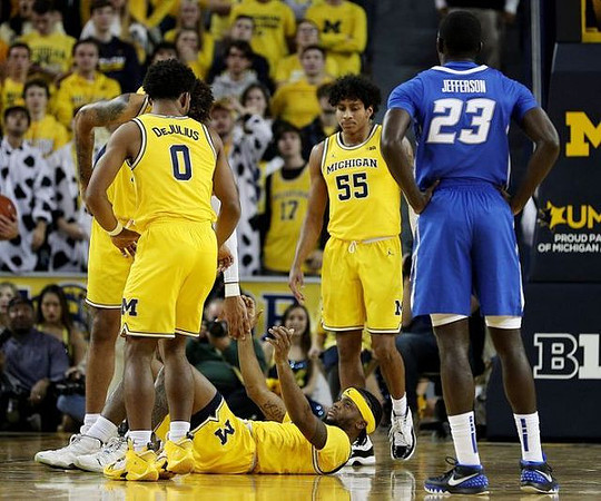 David DeJulius (0), Eli Brooks (55), and Zavier Simpson (3)