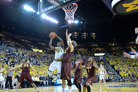 Zak Irvin (21), Caris LeVert (23), and Spike Albrecht (2)