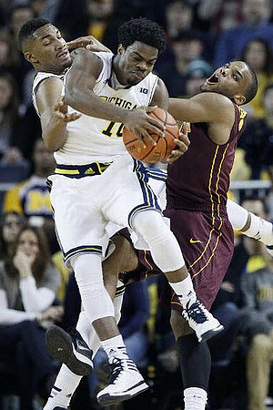 Zak Irvin (21) and Derrick Walton Jr. (10)