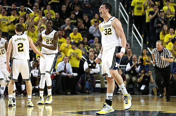 Spike Albrecht (2), Caris LeVert (23), and Ricky Doyle (32)