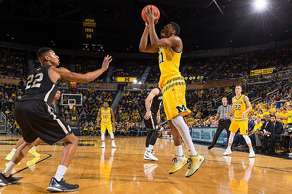 Derrick Walton Jr. (10), Zak Irvin (21), and Duncan Robinson (22)