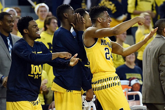 Derrick Walton Jr. (10), Caris LeVert (23), and Aubrey Dawkins (24)