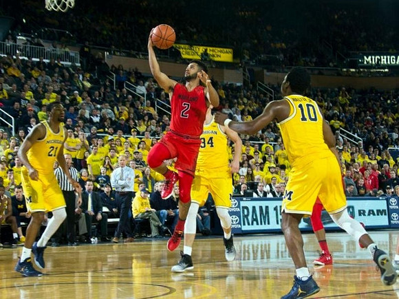 Zak Irvin (21), Mark Donnal (34), and Derrick Walton Jr. (10)