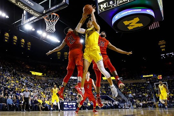 D.J. Wilson (5), Zak Irvin (21), and Derrick Walton Jr. (10)