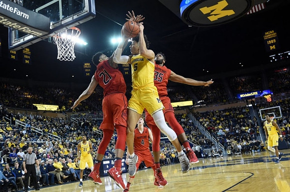 D.J. Wilson (5), Zak Irvin (21), and Derrick Walton Jr. (10)