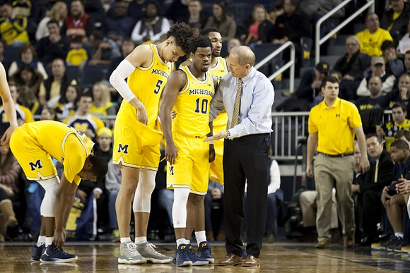 Muhammad-Ali Abdur-Rahkman (12), D.J. Wilson (5), Derrick Walton Jr. (10), Zak Irvin (21), and John Beilein