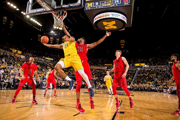 Zak Irvin (21), D.J. Wilson (5), and Mark Donnal (34)