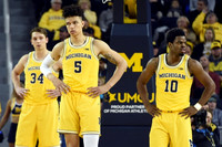 Mark Donnal (34), D.J. Wilson (5), and Derrick Walton Jr. (10)