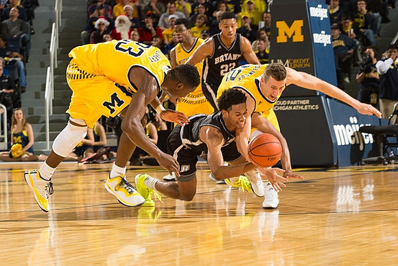 Caris LeVert (23), Derrick Walton Jr. (10), and Duncan Robinson (22)