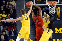 Moritz Wagner (13) and D.J. Wilson (5)