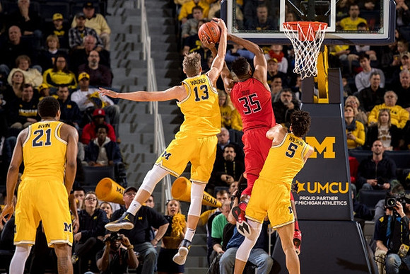Zak Irvin (21), Moritz Wagner (13), and D.J. Wilson (5)