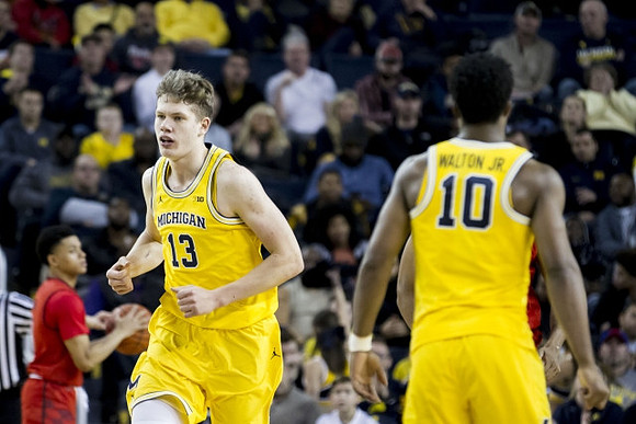 Moritz Wagner (13) and Derrick Walton Jr. (10)
