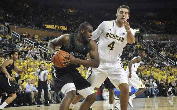 Mitch McGary (4) and Caris LeVert (23)