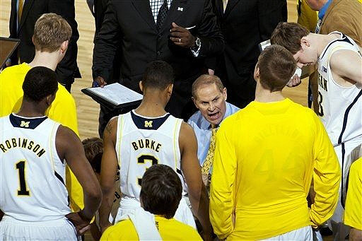 Blake McLimans (22), Glenn Robinson III (1), Trey Burke (3), Max Bielfeldt (44), Matt Vogrich (13), and John Beilein
