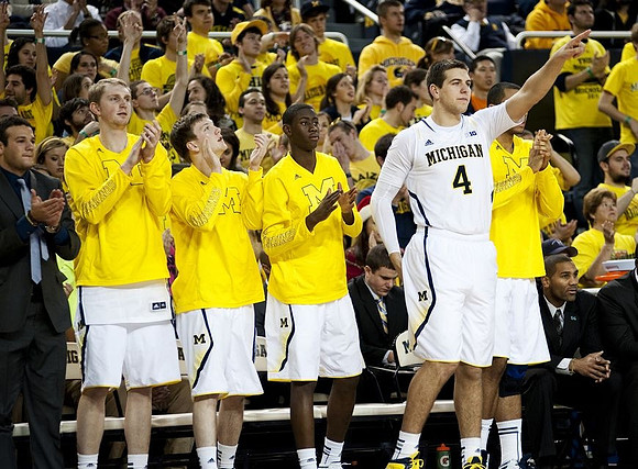 Josh Bartelstein (20), Blake McLimans (22), Matt Vogrich (13), Caris LeVert (23), Mitch McGary (4), and LaVall Jordan