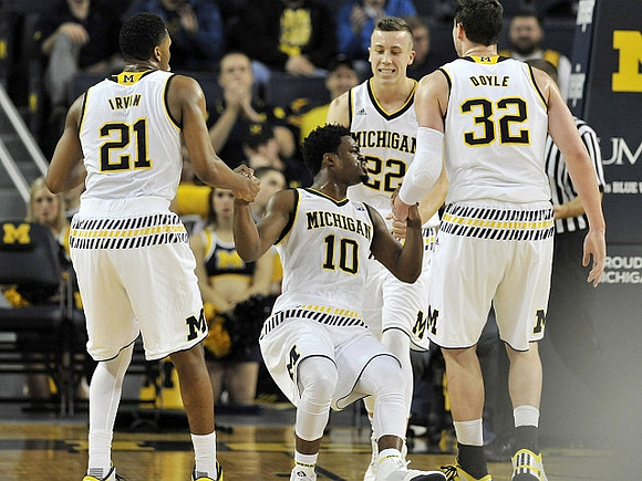 Zak Irvin (21), Derrick Walton Jr. (10), Duncan Robinson (22), and Ricky Doyle (32)