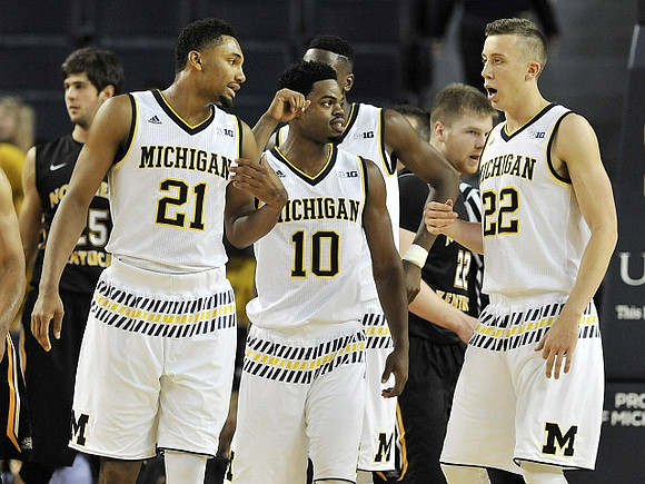Zak Irvin (21), Derrick Walton Jr. (10), and Duncan Robinson (22)