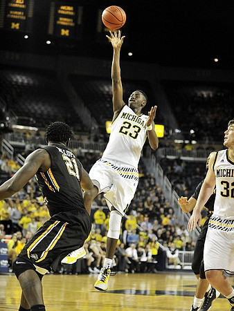 Caris LeVert (23) and Ricky Doyle (32)