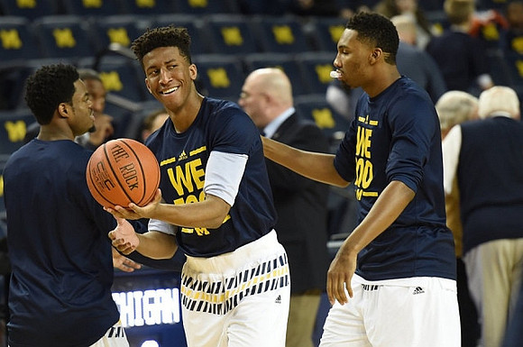 Derrick Walton Jr. (10), Aubrey Dawkins (24), and Zak Irvin (21)