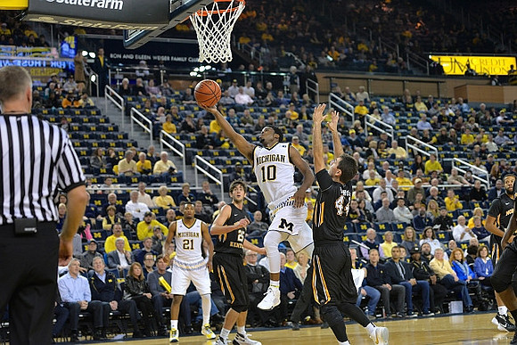 Zak Irvin (21) and Derrick Walton Jr. (10)