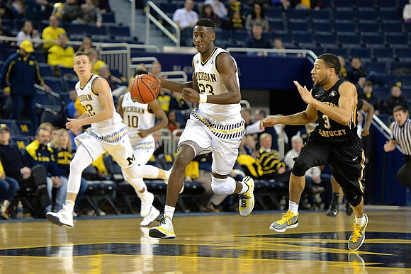 Duncan Robinson (22), Derrick Walton Jr. (10), and Caris LeVert (23)